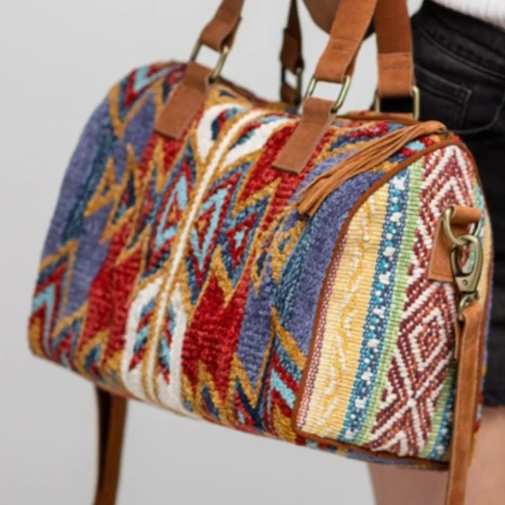 Beautiful woven Winthrop Boston Bagwith genuine suede handle and tassel detail.
